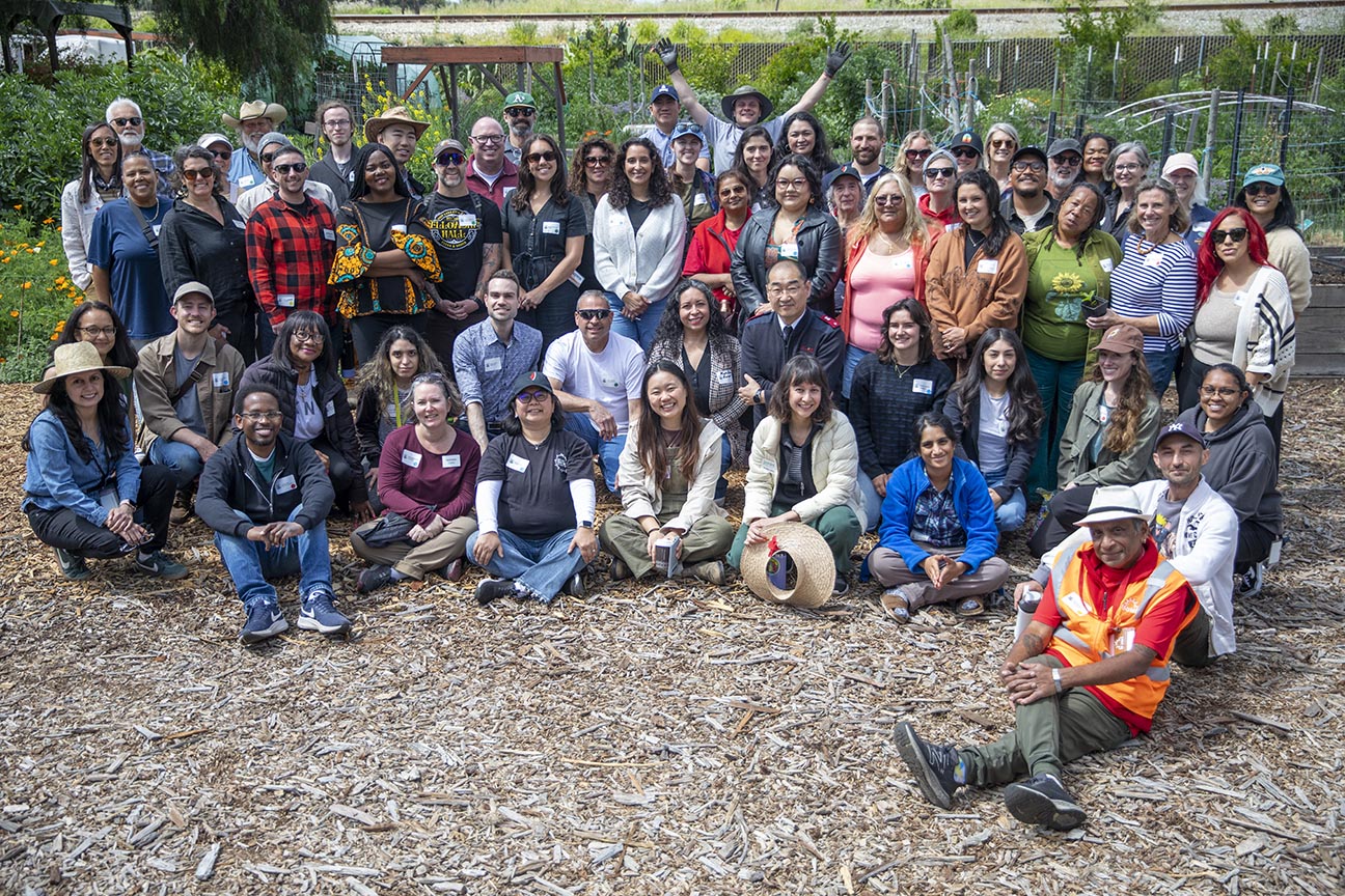 Group shot of more than 30 people in an urban farm