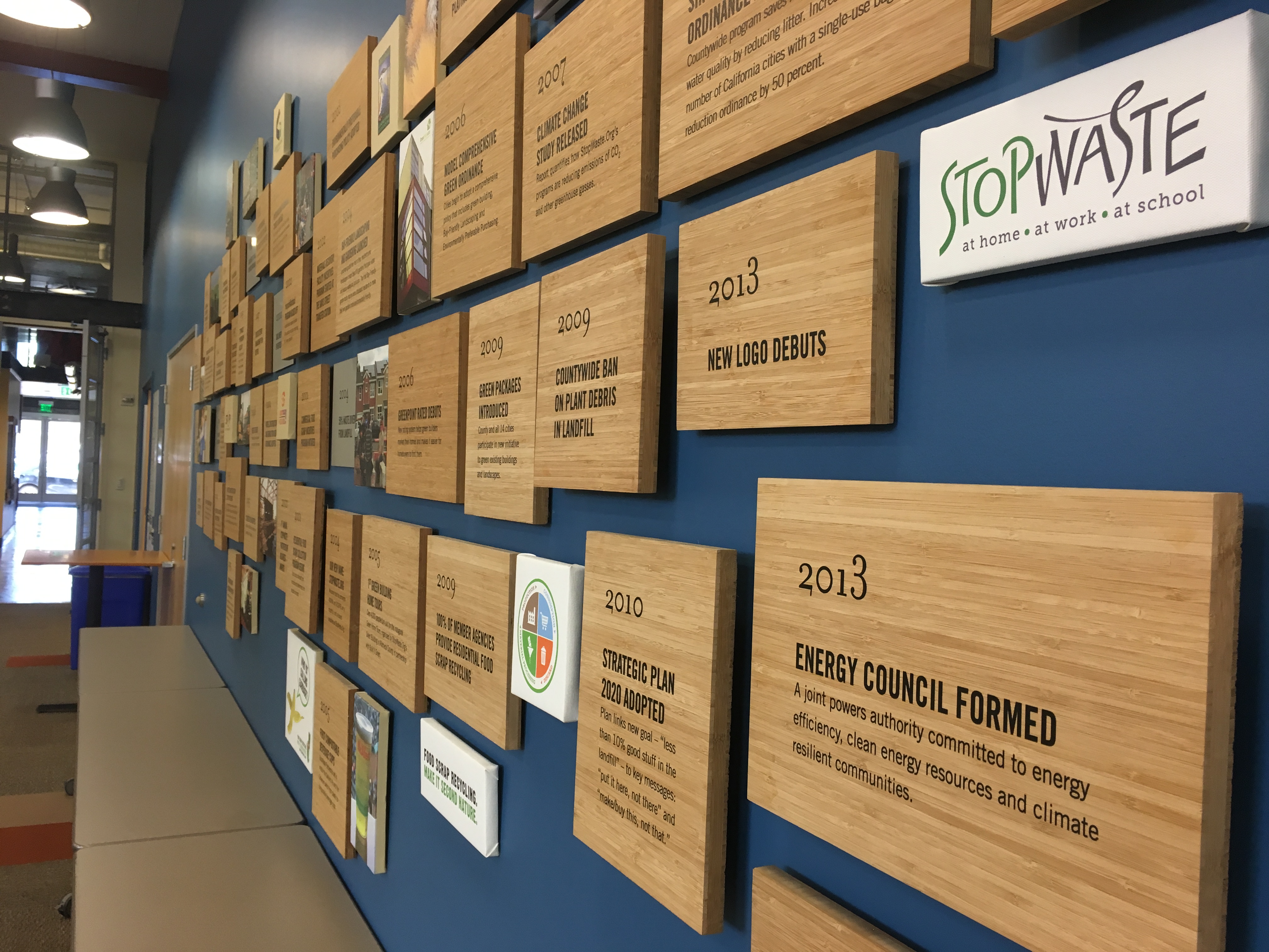 a series of tiles on a wall explaining stopwaste history