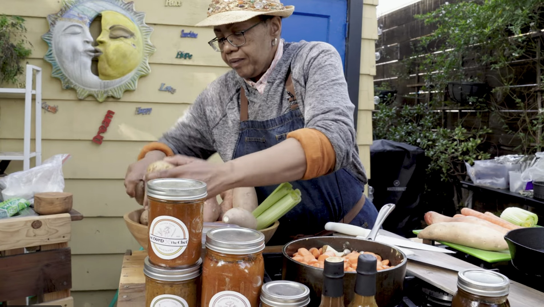 Chef Sarah at an outdoor table with local produce