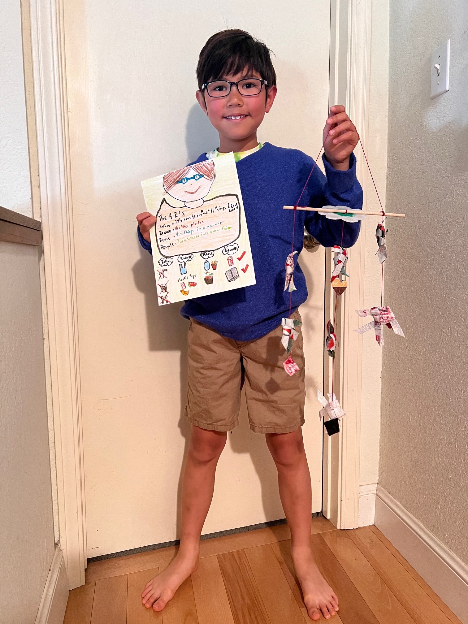 student holding up their contest entry