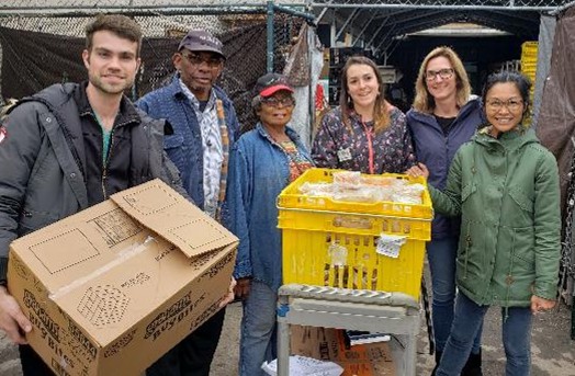 A group of people donating surplus school meals to a food recovery partner