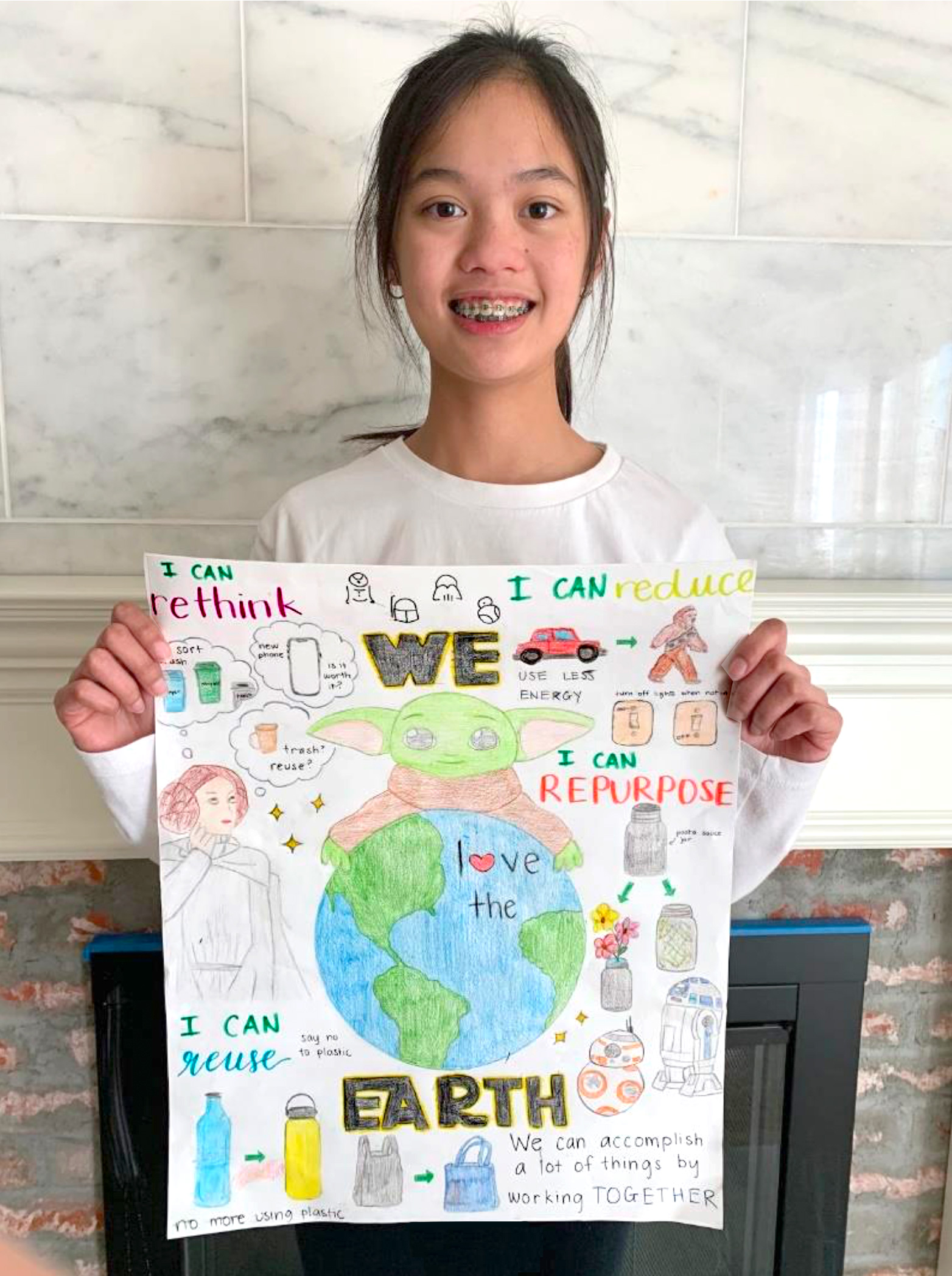 school kid posing with their art project