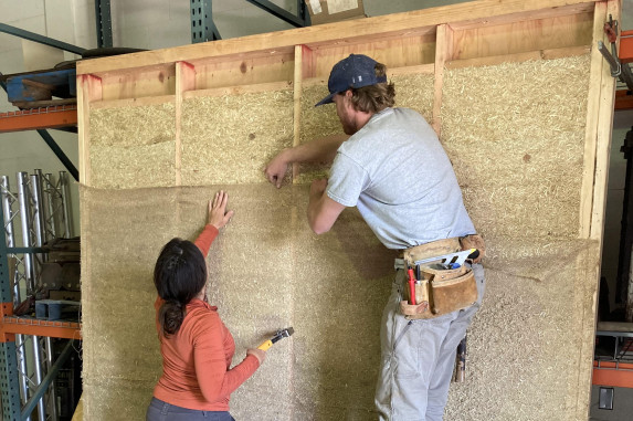Man and woman testing building panel