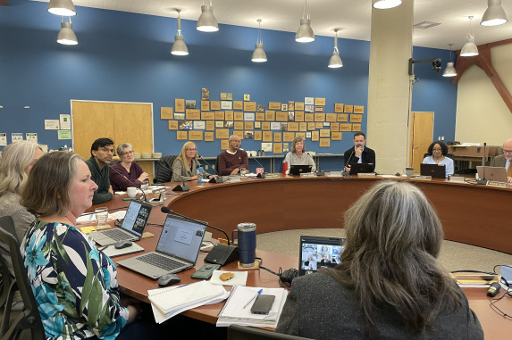 Individuals sitting at round table