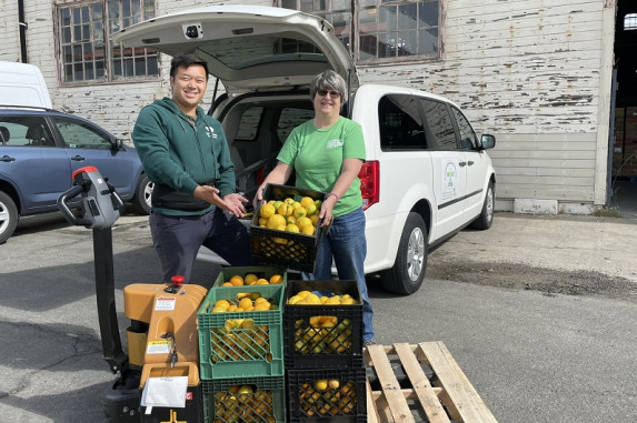 Two people with gleaned harvest