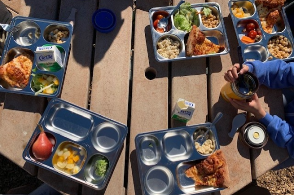 Bird's eye view of student lunches in reusable trays
