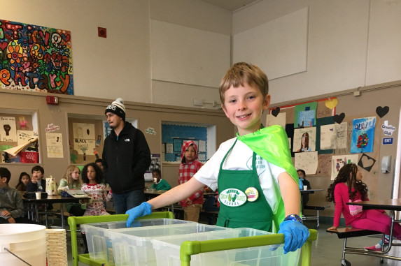 Student helping with the food share cart at school