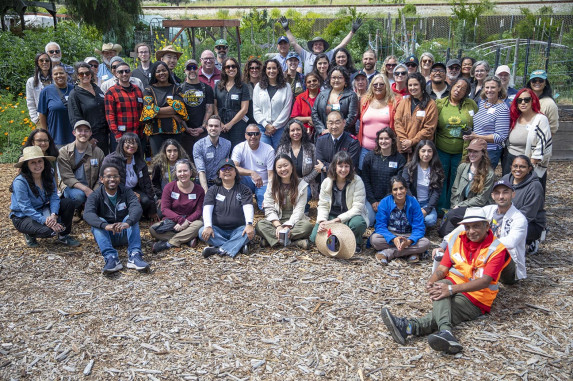 Group shot of more than 30 people in an urban farm