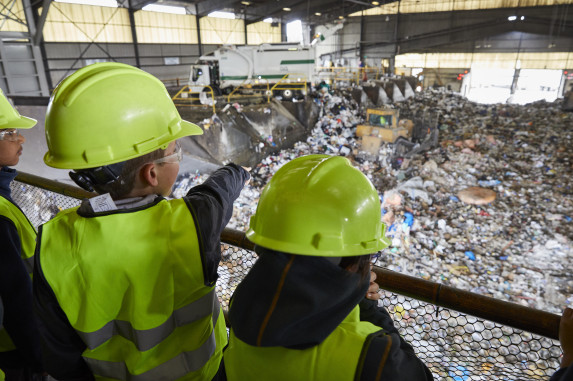 Students looking out at a garbage pit
