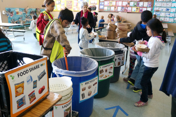 School kids sorting materials in the cafeteria and food share line