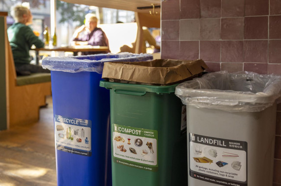 recycling, composting, and landfill bins at a restaurant