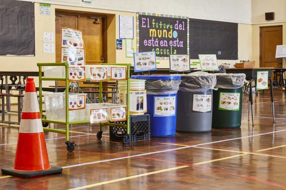 Cafeteria sorting station with compost, recycle, landfill, liquid pour, food share, and tray stacking
