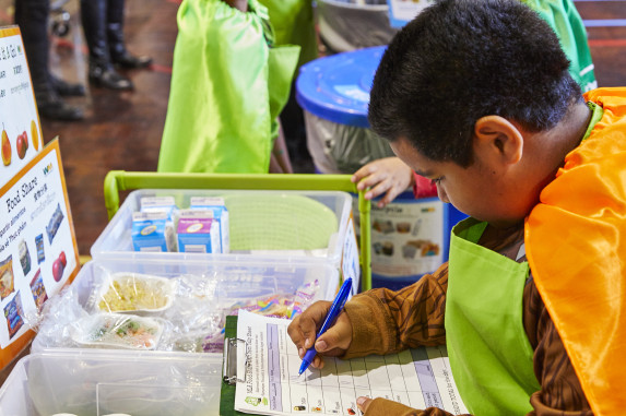 Student recording donated food at the food share table