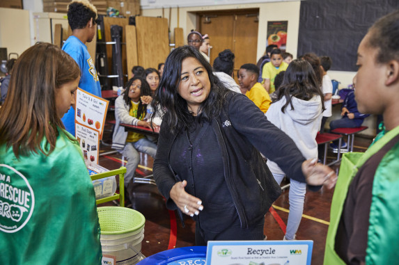 Adult providing support to students in cafeteria