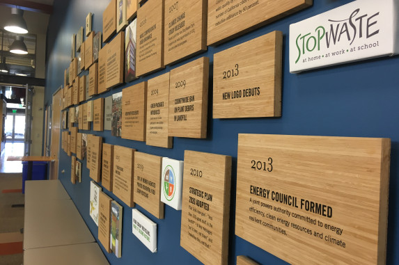 a series of tiles on a wall explaining stopwaste history