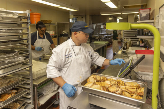 Man weighing tray of food