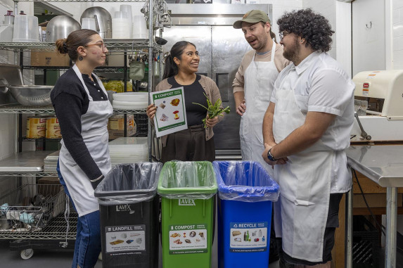 Woman training staff in commercial kitchen