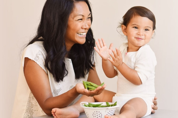 Mother and her child eating peas