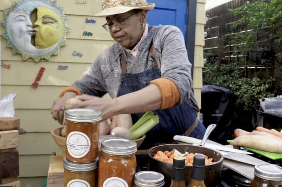 Chef Sarah at an outdoor table with local produce