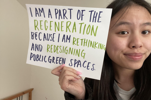 A student holding a sign showing how they are part of the ReGeneration