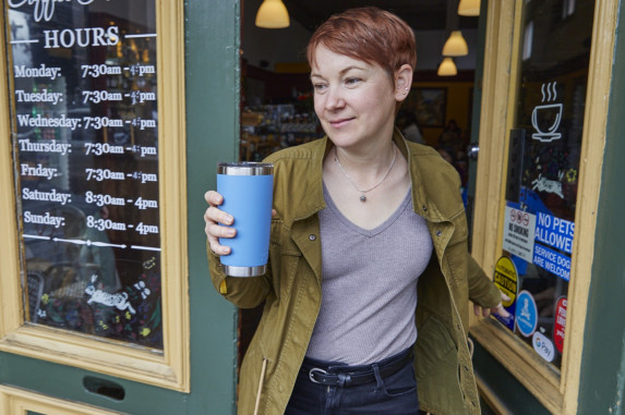 person leaving cafe with BYO cup