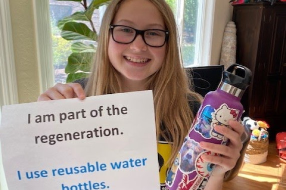 Youth holding a reusable water bottle