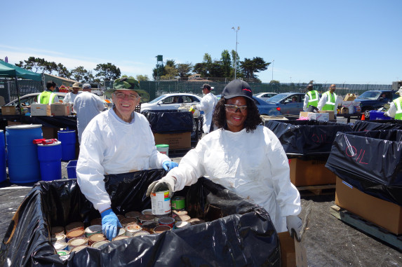 Two technicians unloading household hazardous waste