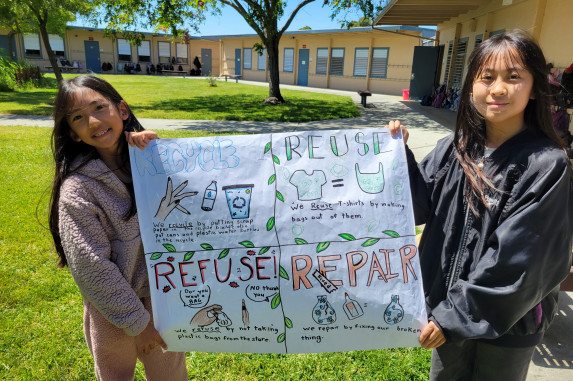 Students holding up their 4Rs poster