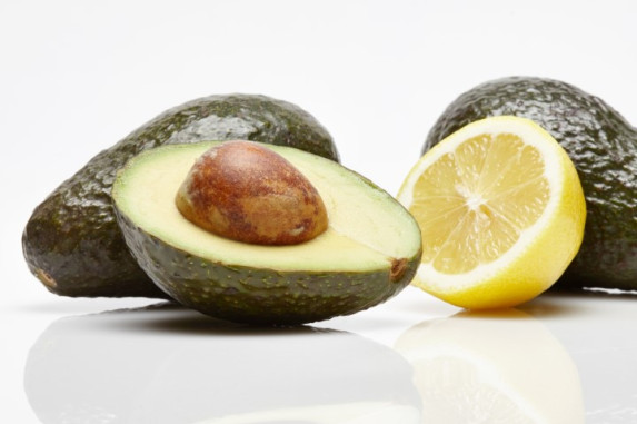 sliced avocado with lemon on side