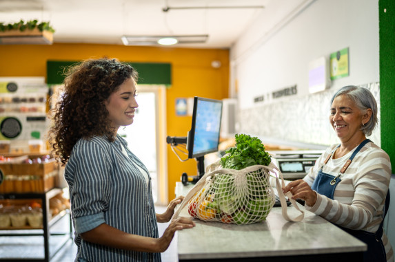 Customer shops with a reusable bag at a grocery store