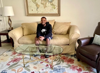 Client sitting on couch in his new home